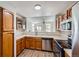 Well-maintained kitchen with wood cabinets, modern appliances, and bright lighting at 8898 W Plymouth Ave, Littleton, CO 80128