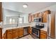 The kitchen features stainless steel appliances, wooden cabinets, and light countertops at 8898 W Plymouth Ave, Littleton, CO 80128