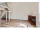 Bright living room with hardwood floors, a modern fireplace and staircase to the second floor at 8898 W Plymouth Ave, Littleton, CO 80128