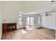 Airy living room with a fireplace, light wood floors, and sliding glass doors to outdoor space at 8898 W Plymouth Ave, Littleton, CO 80128