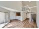 Bright, airy living area showcasing an open staircase, wood floors, and natural light at 8898 W Plymouth Ave, Littleton, CO 80128