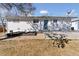 White brick home with a patio, garden, and blue door at 2408 E Cresthill Ave, Centennial, CO 80121