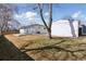 Exterior of white brick house with a grass yard and shade trees at 2408 E Cresthill Ave, Centennial, CO 80121