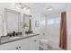Modern bathroom features double sinks, large mirrors, tile floors, and bathtub with shower at 2408 E Cresthill Ave, Centennial, CO 80121