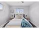 Inviting bedroom featuring side tables, windows, and hardwood floors at 2408 E Cresthill Ave, Centennial, CO 80121