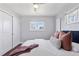 Bedroom featuring hardwood floors, natural light, and closet with double doors for storage at 2408 E Cresthill Ave, Centennial, CO 80121