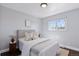 Cozy bedroom with soft natural light, hardwood floors, neutral decor, and stylish side tables at 2408 E Cresthill Ave, Centennial, CO 80121