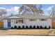 Charming ranch-style home with fresh exterior paint, blue door, new roof, and updated landscaping at 2408 E Cresthill Ave, Centennial, CO 80121
