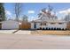 Well-maintained exterior of ranch home with detached garage, long driveway, and updated landscaping at 2408 E Cresthill Ave, Centennial, CO 80121