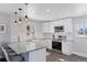 Bright kitchen with stainless appliances, white cabinets, granite countertops, and modern fixtures at 2408 E Cresthill Ave, Centennial, CO 80121