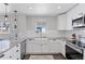 Updated kitchen featuring white cabinets, granite counters, stainless steel appliances, and modern fixtures at 2408 E Cresthill Ave, Centennial, CO 80121
