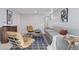 Well-lit living room with a grey couch, plants, and modern furniture at 2408 E Cresthill Ave, Centennial, CO 80121