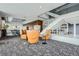 Elegant lounge area with comfortable seating, a well-stocked bookshelf, and a modern staircase for relaxation and socializing at 891 14Th St # 2205, Denver, CO 80202