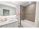 Modern bathroom with walk-in shower, sleek vanity, and large, illuminated mirror at 1300 N Ogden St # 204, Denver, CO 80218