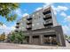 Striking condo building with black trim, balconies, and contemporary design stands out against the blue sky at 1300 N Ogden St # 204, Denver, CO 80218
