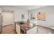 Open kitchen with stainless appliances, large island with seating, and dining area at 1300 N Ogden St # 204, Denver, CO 80218