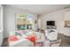 Bright and airy living room featuring hardwood floors, a modern sofa, and a balcony with outdoor seating at 1300 N Ogden St # 204, Denver, CO 80218