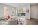 Inviting living room boasts hardwood floors, a cozy sofa, large windows, and access to a charming balcony at 1300 N Ogden St # 204, Denver, CO 80218