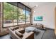 Community lounge area with comfortable seating, a large window and brick walls at 1300 N Ogden St # 204, Denver, CO 80218