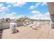 Rooftop deck showcasing skyline views with tables and chairs at 1300 N Ogden St # 204, Denver, CO 80218