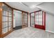 A unique basement space with carpet and red-framed doors at 8918 W 101St Ave, Broomfield, CO 80021