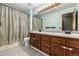 Bathroom featuring a double sink vanity, a large mirror, and a shower at 8918 W 101St Ave, Broomfield, CO 80021