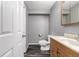 Bathroom featuring wood-look flooring, a toilet, a sink, and a neutral color scheme at 8918 W 101St Ave, Broomfield, CO 80021