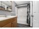 Bathroom featuring a bathtub with shower, a vanity, and wood look flooring at 8918 W 101St Ave, Broomfield, CO 80021