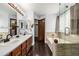 Bathroom features a double sink vanity, a bathtub, and a glass-enclosed shower at 8918 W 101St Ave, Broomfield, CO 80021