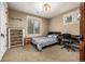 Cozy bedroom featuring a bed, dresser, desk, and a warm, inviting ambiance at 8918 W 101St Ave, Broomfield, CO 80021