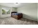 Inviting bedroom with a unique wood frame bed, plush carpet, and natural light at 8918 W 101St Ave, Broomfield, CO 80021