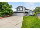 Charming two-story home with a three-car garage, beautiful landscaping, and a well-manicured lawn at 8918 W 101St Ave, Broomfield, CO 80021