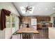 Bright kitchen with skylights, wooden cabinetry, stainless steel appliances, and a dining area with access to the backyard at 8918 W 101St Ave, Broomfield, CO 80021