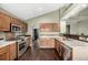 Kitchen features wood cabinetry, stainless steel appliances, granite countertops and backsplash details at 8918 W 101St Ave, Broomfield, CO 80021