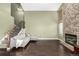 Open living room with stone fireplace, hardwood floors, and a staircase to the upper level at 8918 W 101St Ave, Broomfield, CO 80021