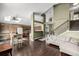 Open-concept living room with wood floors, a staircase, and access to the kitchen area featuring bright, natural light at 8918 W 101St Ave, Broomfield, CO 80021