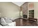Comfortable living room featuring a stone fireplace, hardwood floors, and large windows at 8918 W 101St Ave, Broomfield, CO 80021