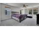 Bright bedroom with a black frame bed, carpeted floors, and natural light from multiple windows at 18947 E 57Th Pl, Denver, CO 80249