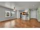 Open dining area with breakfast bar, hardwood floors, and lots of natural light at 18947 E 57Th Pl, Denver, CO 80249