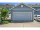A detached one-car garage features a white door and ample parking at 18947 E 57Th Pl, Denver, CO 80249
