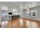 Bright living room with hardwood floors, ceiling fan, and access to an outdoor patio at 18947 E 57Th Pl, Denver, CO 80249