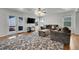 Comfortable living room with plush seating, ceiling fan, and access to outdoor deck at 18947 E 57Th Pl, Denver, CO 80249