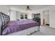 Spacious main bedroom with a large bed, carpet, and an ensuite bathroom at 18947 E 57Th Pl, Denver, CO 80249