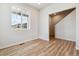 Bright room with wood floors, a large window, and staircase entrance, offering a versatile space at 4285 Gozzer Ranch Dr, Elizabeth, CO 80107