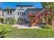 Rear exterior view of a house featuring a deck, patio, and well-maintained lawn at 9261 Millcreek Ct, Highlands Ranch, CO 80126