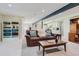 Comfortable basement living room with a plush leather sofa and built-in shelving at 9261 Millcreek Ct, Highlands Ranch, CO 80126