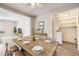 Comfortable dining area with a wooden table and open access to a washer and dryer room at 12143 Melody Dr # 104, Denver, CO 80234