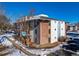 Bright multi-Gathering building featuring a mix of red brick and white stucco siding under a clear blue sky at 12143 Melody Dr # 104, Denver, CO 80234