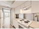 Clean kitchen with white appliances and view to the backyard through sliding glass doors at 12143 Melody Dr # 104, Denver, CO 80234
