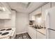 Well-lit kitchen featuring white appliances, ample counter space, and modern cabinetry at 12143 Melody Dr # 104, Denver, CO 80234